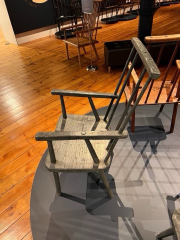 An antique chair in worn original paint.