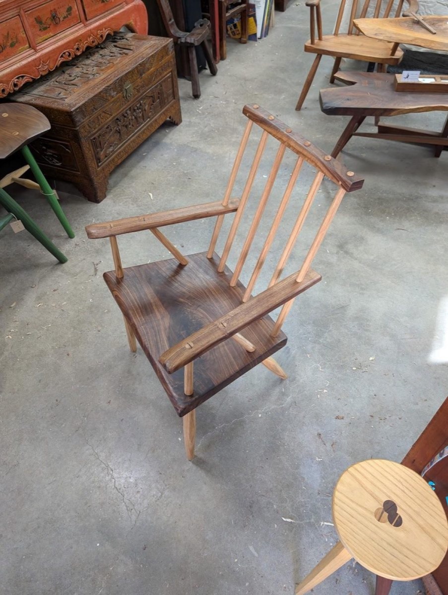 A two-timber chair in pale oak and dark walnut, its wedged tenon tops standing proud.