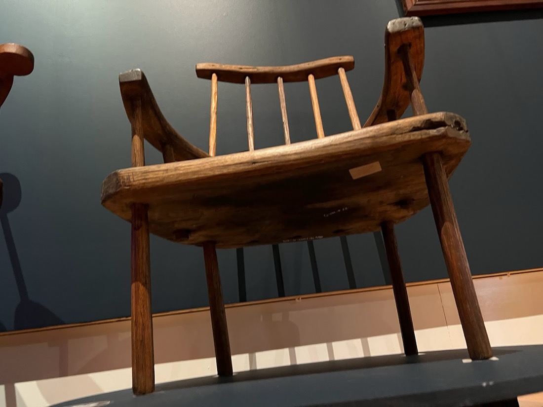 A Jimmy Possum armchair in richly figured wood.