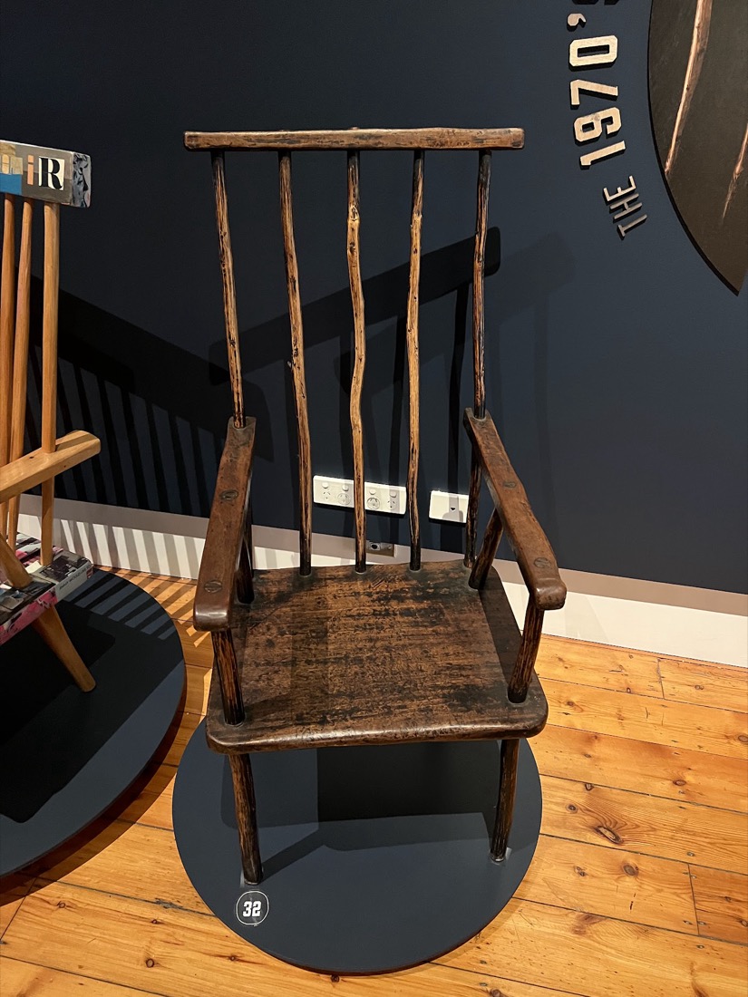 A tall-backed Jimmy Possum stick chair in dark timber.