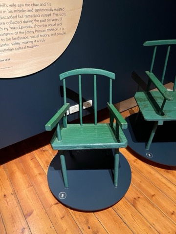 A small chair in worn green house paint.